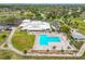 Aerial view showcasing the clubhouse, golf course, swimming pool, and lush green surroundings at 3408 Idlegrove Ct, Orlando, FL 32822