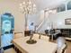 The dining room features a crystal chandelier, a dining table and opens to the living room at 3408 Idlegrove Ct, Orlando, FL 32822