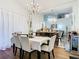 The formal dining room has a chandelier, a bar in the background, and hardwood floors at 3408 Idlegrove Ct, Orlando, FL 32822