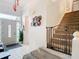 This beautiful entryway features tile floors, a staircase, and an ornate front door with sidelights at 3408 Idlegrove Ct, Orlando, FL 32822