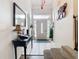 Bright entryway featuring a decorative mirror, console table, tiled flooring, and a front door with ornate glass at 3408 Idlegrove Ct, Orlando, FL 32822