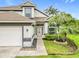 Charming home with a two-car garage, well-manicured lawn, and beautiful landscaping at 3408 Idlegrove Ct, Orlando, FL 32822