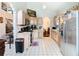 This kitchen offers light wood cabinetry, white tile flooring, and stainless steel appliances at 3408 Idlegrove Ct, Orlando, FL 32822