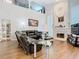 Spacious living room with high ceilings, a fireplace, and comfortable seating creates a welcoming atmosphere at 3408 Idlegrove Ct, Orlando, FL 32822