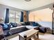 A cozy living room features a comfortable sectional sofa and a view into the upstairs loft at 3408 Idlegrove Ct, Orlando, FL 32822