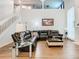 Living area has an open staircase, large windows, and leather sofa at 3408 Idlegrove Ct, Orlando, FL 32822