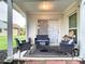 Covered patio area with black wicker furniture including chairs, love seat and coffee table at 3408 Idlegrove Ct, Orlando, FL 32822