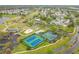 Aerial view of tennis courts, playground, lake, and golf course in a vibrant residential community at 3408 Idlegrove Ct, Orlando, FL 32822