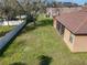 Aerial view of the expansive backyard with new fence, a screened in patio and mature tree coverage at 3620 Chandler Estates Dr, Apopka, FL 32712