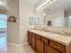 Bathroom vanity featuring double sinks, granite countertops and ample storage space at 3620 Chandler Estates Dr, Apopka, FL 32712