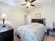A comfortable bedroom featuring a floral bedspread, dark wood furniture and a ceiling fan at 3620 Chandler Estates Dr, Apopka, FL 32712