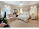 Bright bedroom with a comfortable sitting chair, complemented by tasteful decorations and a white furniture set at 3620 Chandler Estates Dr, Apopka, FL 32712