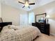 A cozy bedroom featuring a floral bedspread, dark wood furniture and a ceiling fan at 3620 Chandler Estates Dr, Apopka, FL 32712