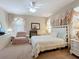 Cozy bedroom featuring a ceiling fan, ample natural light, and complemented by stylish furnishings at 3620 Chandler Estates Dr, Apopka, FL 32712