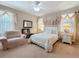 Charming bedroom featuring a ceiling fan, a luxurious bed and decorated with beautiful curtains at 3620 Chandler Estates Dr, Apopka, FL 32712