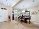 Bright dining area featuring chandelier, wood table, grandfather clock, and tiled floor at 3620 Chandler Estates Dr, Apopka, FL 32712