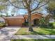 Welcoming one-story home with a two-car garage and a nicely landscaped front yard at 3620 Chandler Estates Dr, Apopka, FL 32712