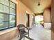 Inviting covered front porch with comfortable seating, perfect for relaxing and enjoying the neighborhood at 3620 Chandler Estates Dr, Apopka, FL 32712