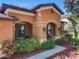 Close up of the welcoming front porch with decorative sconces and lush landscaping at 3620 Chandler Estates Dr, Apopka, FL 32712