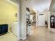Hallway leading to the front door, with tile flooring and access to laundry room at 3620 Chandler Estates Dr, Apopka, FL 32712