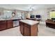 Open kitchen with island, stainless appliances, flowing into living room with patio access at 3620 Chandler Estates Dr, Apopka, FL 32712