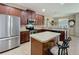 Modern kitchen featuring stainless steel appliances, granite countertops, and center island with seating at 3620 Chandler Estates Dr, Apopka, FL 32712