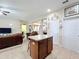 Kitchen island with granite counters and tile floors in an open floor plan at 3620 Chandler Estates Dr, Apopka, FL 32712