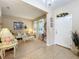Elegant living room with tile and carpet flooring, chandelier and ample natural light at 3620 Chandler Estates Dr, Apopka, FL 32712