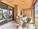 The screened patio includes an outdoor dining area and a view of the backyard at 3620 Chandler Estates Dr, Apopka, FL 32712