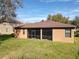 Back of house view showing a screened-in patio overlooking a spacious backyard at 3620 Chandler Estates Dr, Apopka, FL 32712