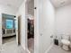 Bathroom with view of bedroom and a walk-in closet, plus a toilet and storage at 3764 Shoveler Ave, Leesburg, FL 34748