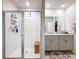 Bright, modern bathroom features a glass-enclosed shower and double vanity with granite countertops at 3764 Shoveler Ave, Leesburg, FL 34748