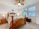 Bedroom featuring a wooden bed frame, ceiling fan, neutral color scheme, and natural light at 3764 Shoveler Ave, Leesburg, FL 34748