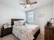 Bedroom with a decorative bed, bedside tables, and lots of natural light at 3764 Shoveler Ave, Leesburg, FL 34748