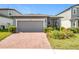 Charming single-Gathering home featuring a brick driveway, well-maintained landscaping, and a neutral color palette at 3764 Shoveler Ave, Leesburg, FL 34748