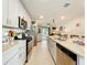 Bright, well-equipped kitchen featuring stainless steel appliances, granite countertops, and ample cabinet space at 3764 Shoveler Ave, Leesburg, FL 34748