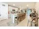 Spacious kitchen island with seating, granite countertops, stainless steel appliances, and modern pendant lighting at 3764 Shoveler Ave, Leesburg, FL 34748