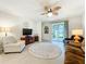 Cozy living room with tile floors, a ceiling fan, access to the lanai and comfortable seating at 3764 Shoveler Ave, Leesburg, FL 34748