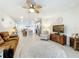 Open-concept living room with a fan, nice decor, and views of the kitchen at 3764 Shoveler Ave, Leesburg, FL 34748
