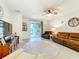 Comfortable living room with a ceiling fan and sliding glass doors to a screened porch at 3764 Shoveler Ave, Leesburg, FL 34748
