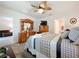 Cozy main bedroom with a ceiling fan and furniture with decorative accents at 3764 Shoveler Ave, Leesburg, FL 34748