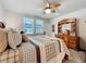 Bright main bedroom with a ceiling fan and a beautiful dresser at 3764 Shoveler Ave, Leesburg, FL 34748