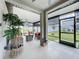 Screened-in lanai with outdoor furniture, decorative plants, and a view of the fenced backyard at 3764 Shoveler Ave, Leesburg, FL 34748