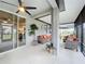 Covered outdoor living space with stylish wicker furniture, ceiling fan, and access to the backyard at 3764 Shoveler Ave, Leesburg, FL 34748
