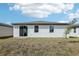 Simple backyard featuring a glass sliding door entry and green grass at 3872 Giorgio Dr, Winter Haven, FL 33884
