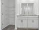 Well-appointed bathroom with granite countertops, dual sinks, modern fixtures, and organized shelving at 3872 Giorgio Dr, Winter Haven, FL 33884