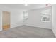 Well-lit bedroom with gray carpet and large windows creating a bright, airy space at 3872 Giorgio Dr, Winter Haven, FL 33884