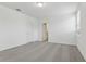 Bright bedroom featuring plush gray carpet, a modern light fixture and a view to a bathroom at 3872 Giorgio Dr, Winter Haven, FL 33884