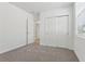 A cozy bedroom featuring plush carpet and a spacious closet for ample storage at 3872 Giorgio Dr, Winter Haven, FL 33884