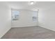 Bright and airy bedroom featuring plush carpeting, and abundant natural light from two large windows at 3872 Giorgio Dr, Winter Haven, FL 33884